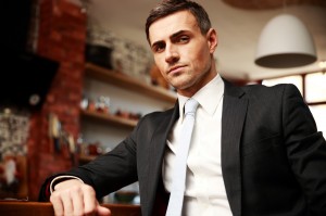 Confident businessman in formal cloths resting in the kitchen